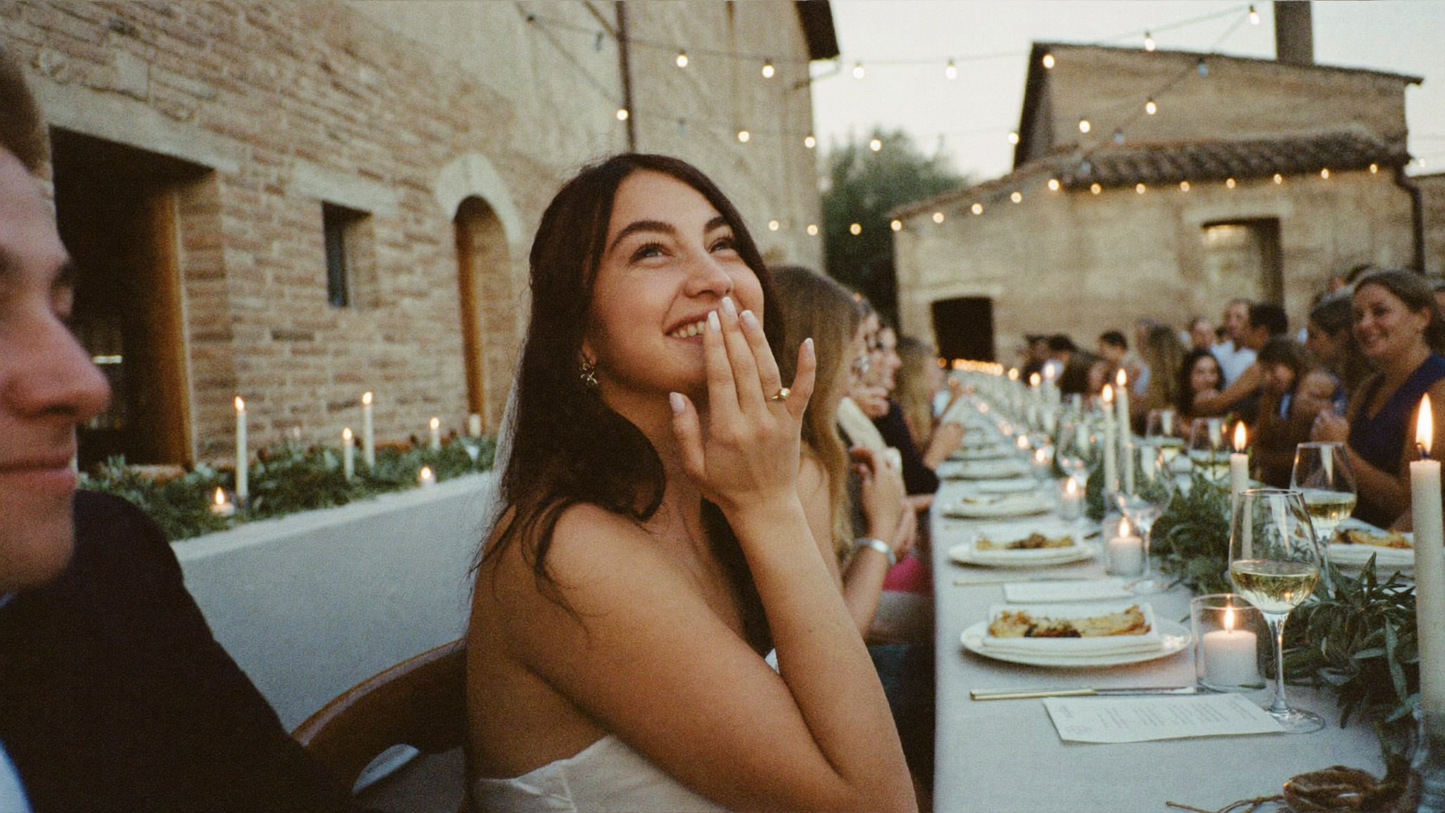 A candid Tuscan wedding scene at golden hour