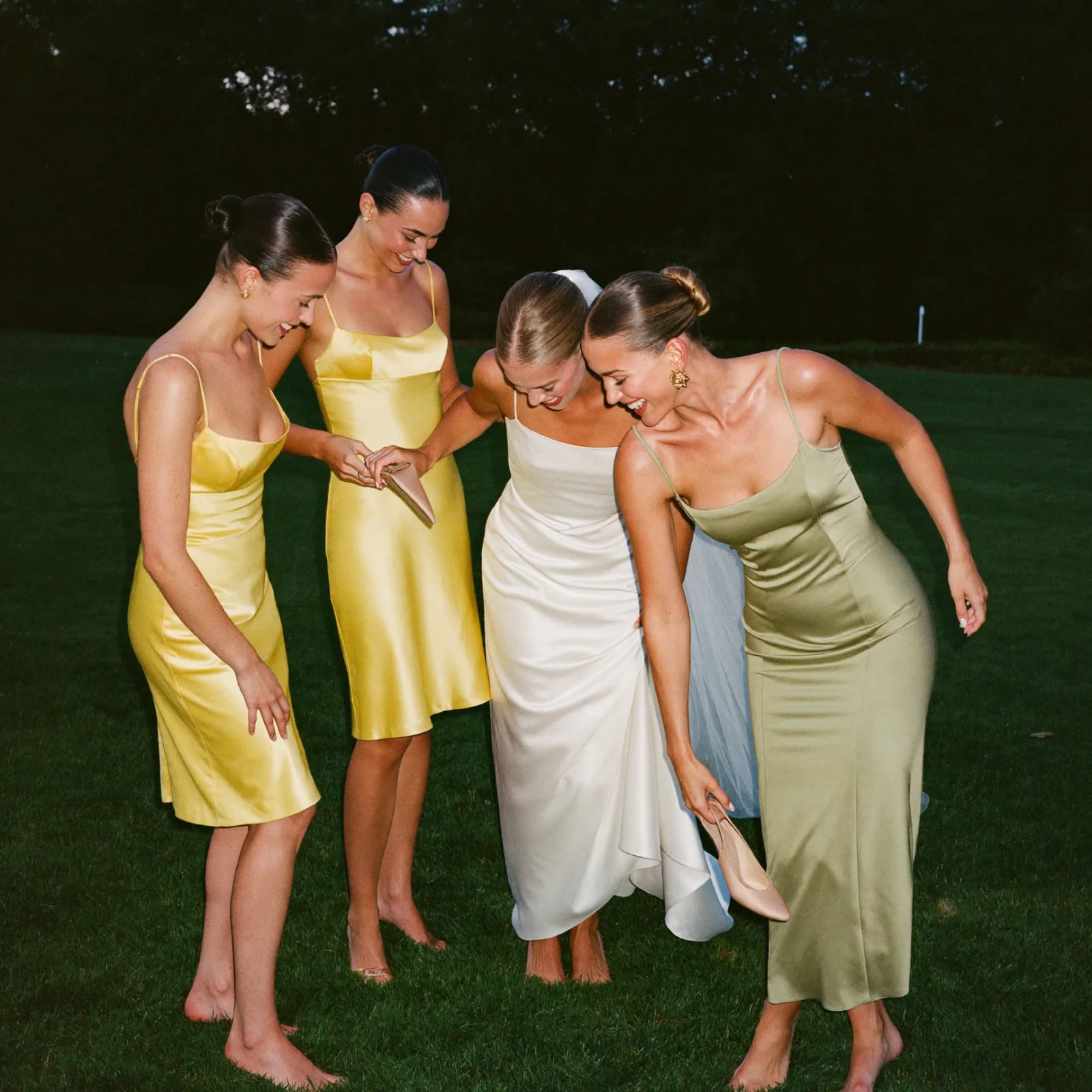 Guests relaxing barefoot on the lawn at a wedding