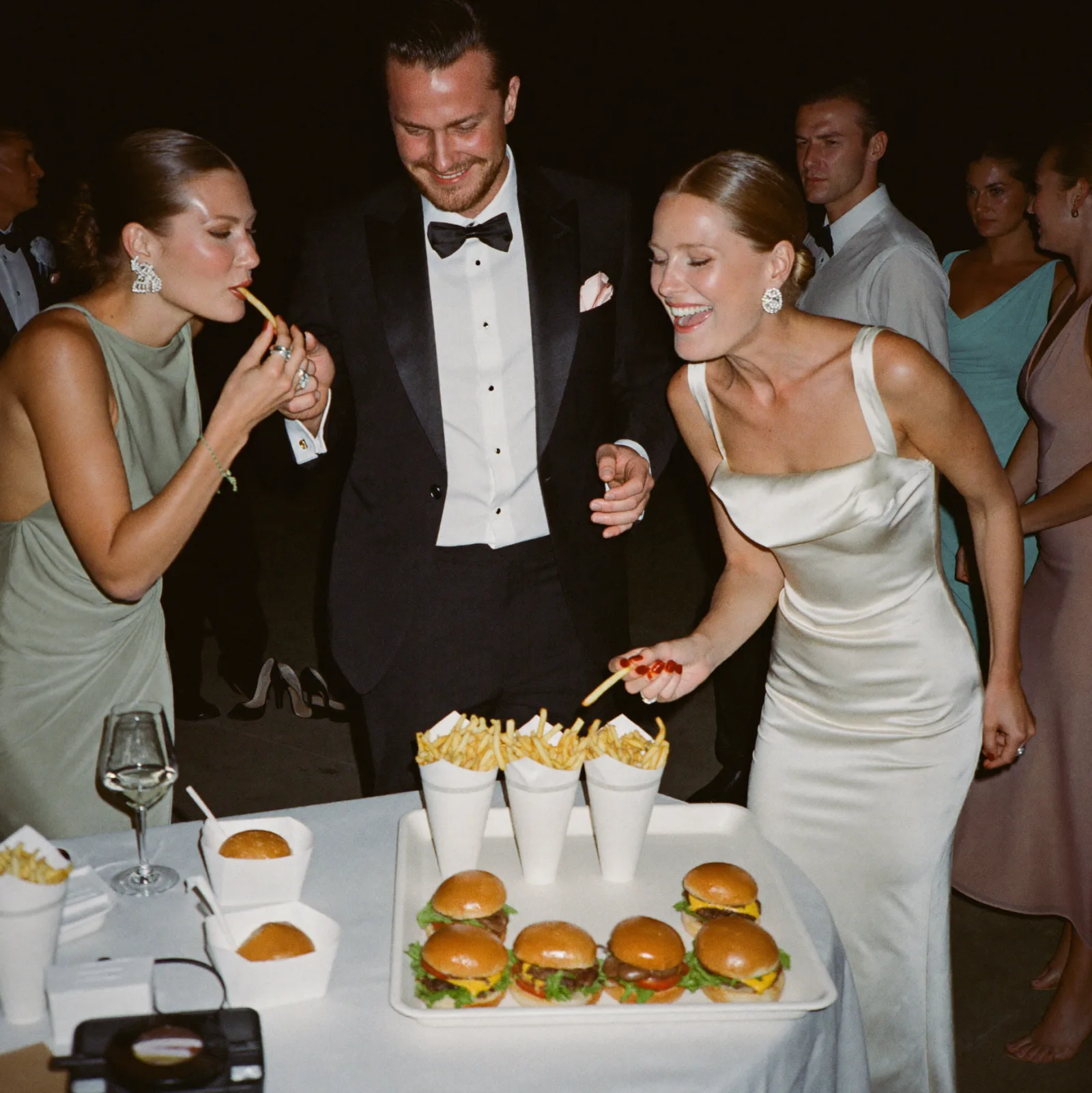 Guests sharing late-night fries after the reception