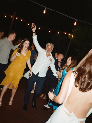 Guests on a crowded dance floor at night