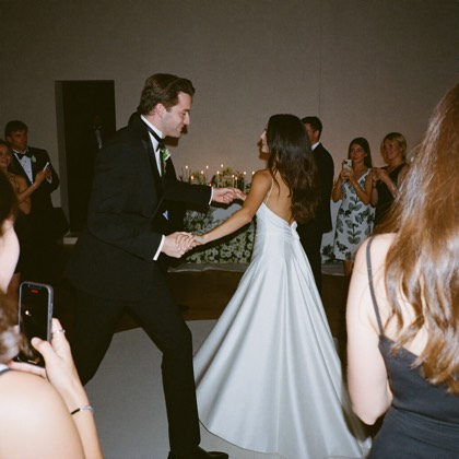 Couple sharing their first dance, seen from a guest's phone