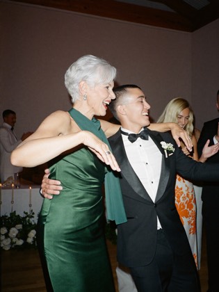 Older guest dancing with the groom